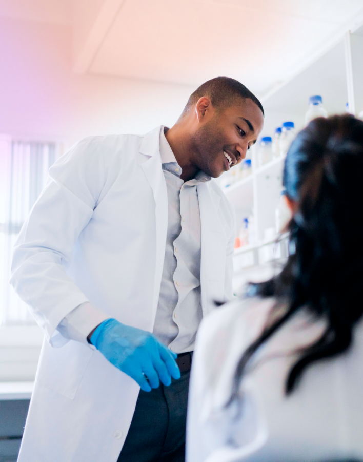 Man and woman in a lab wearing lab coats