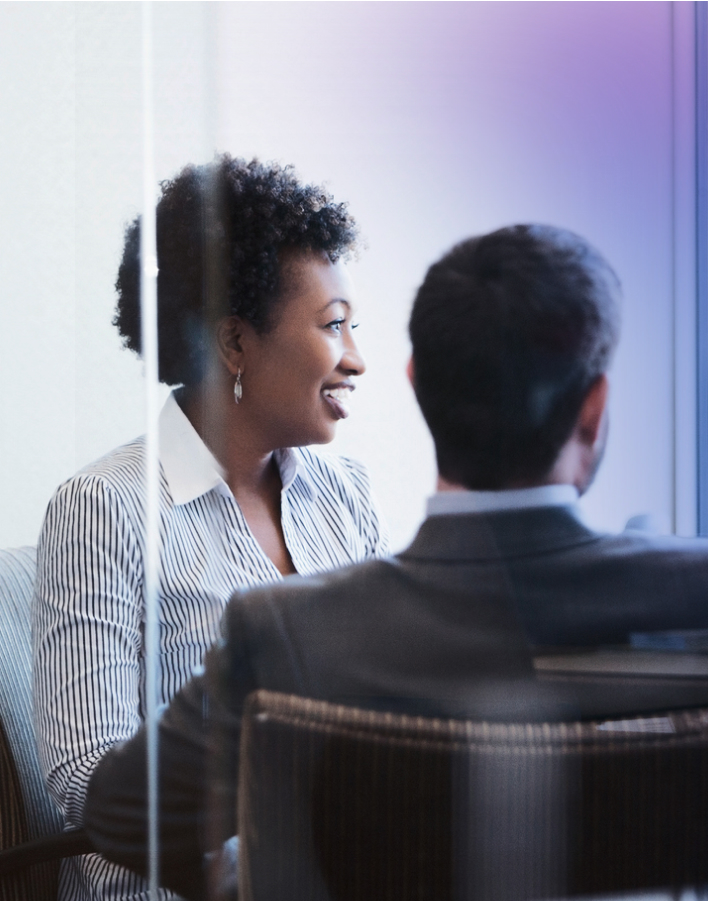 woman and man in a conference room